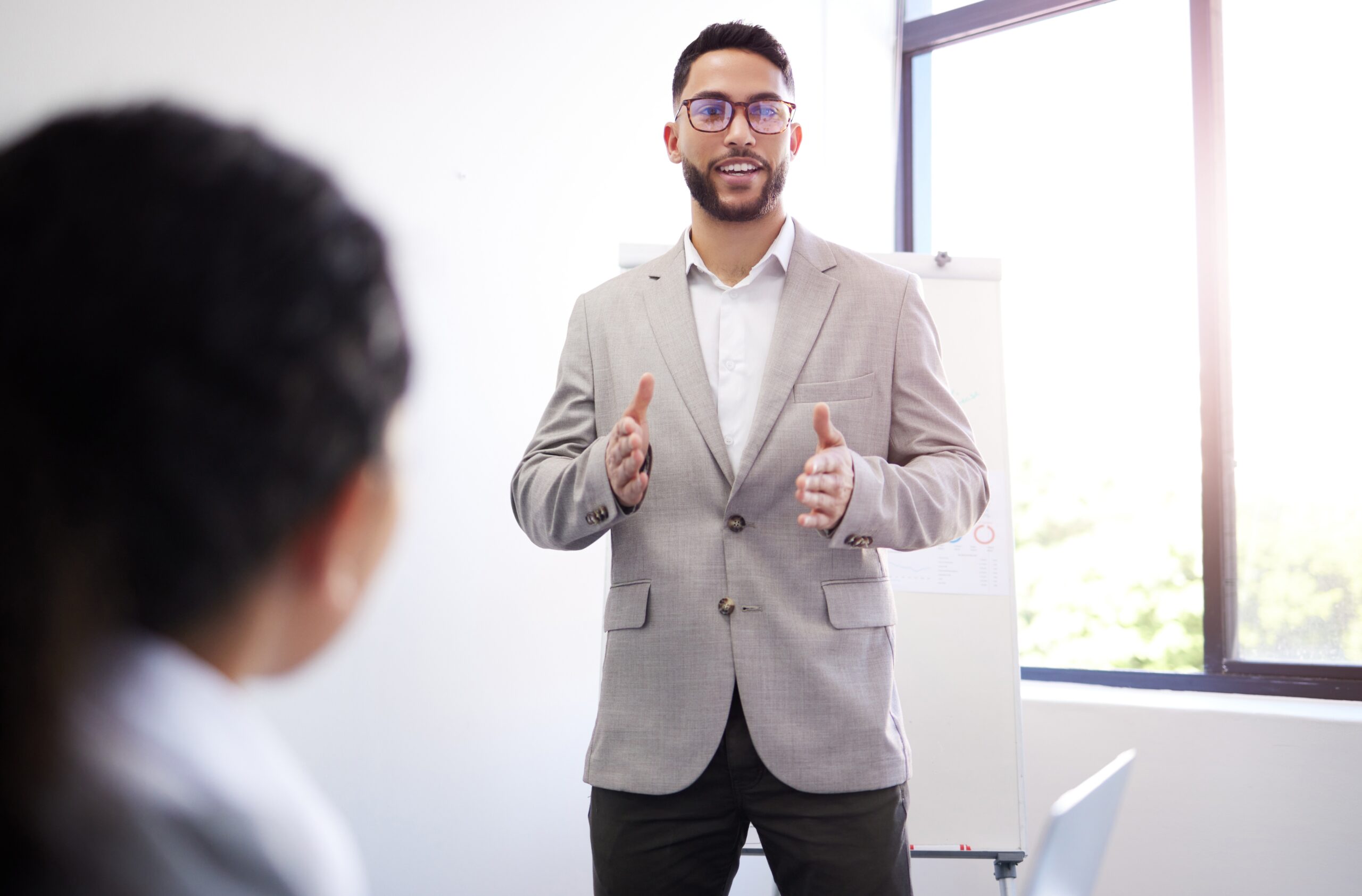 Sales professional making a sales pitch to business clients