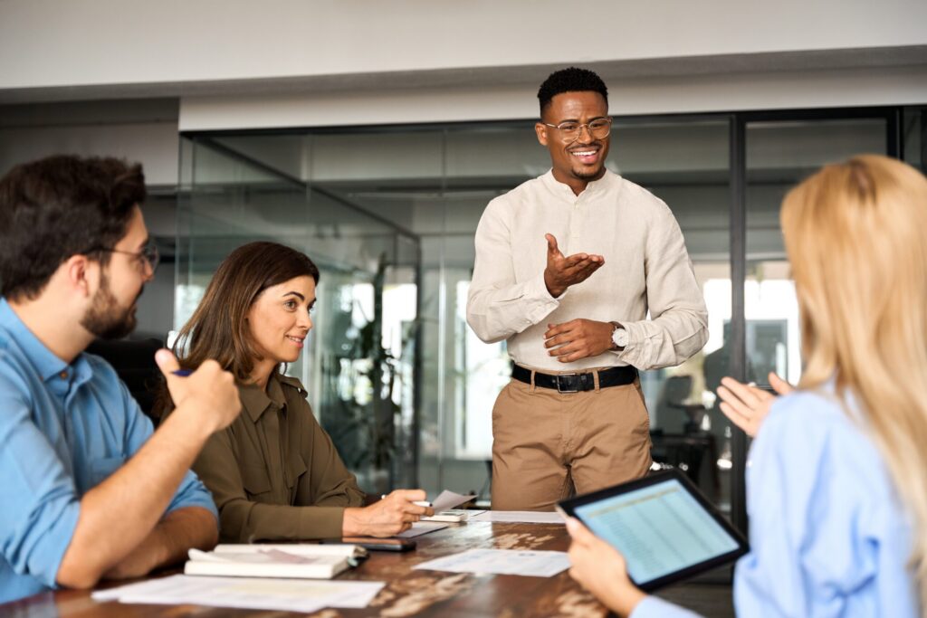 Young professional talking about leadership to his colleagues