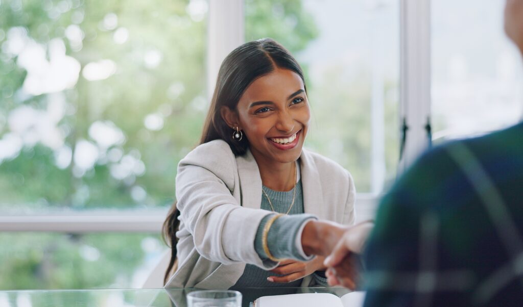 Direct sales professional shaking hands with a business client