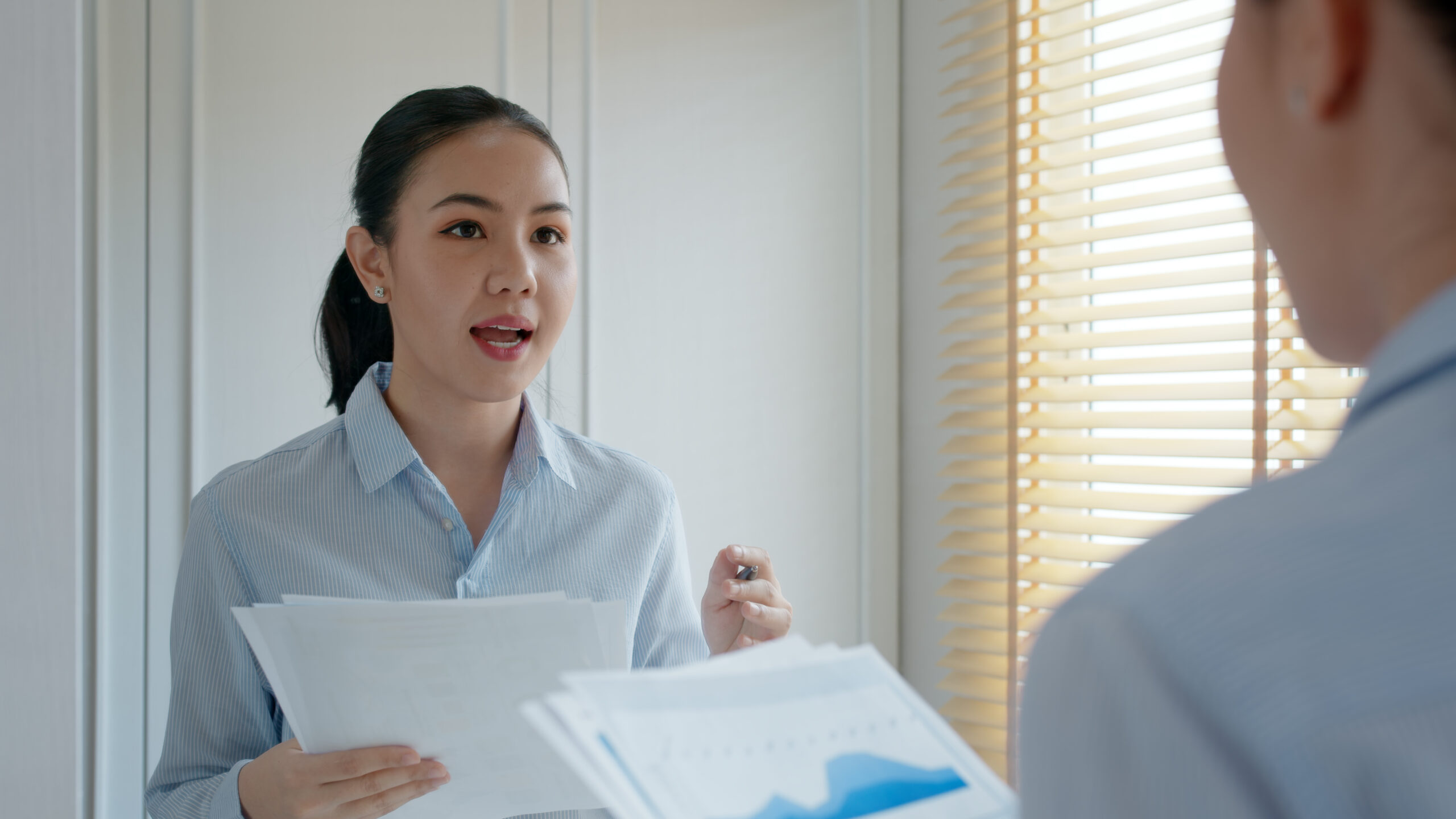 A sales professional practicing her presentation in front of a mirror.